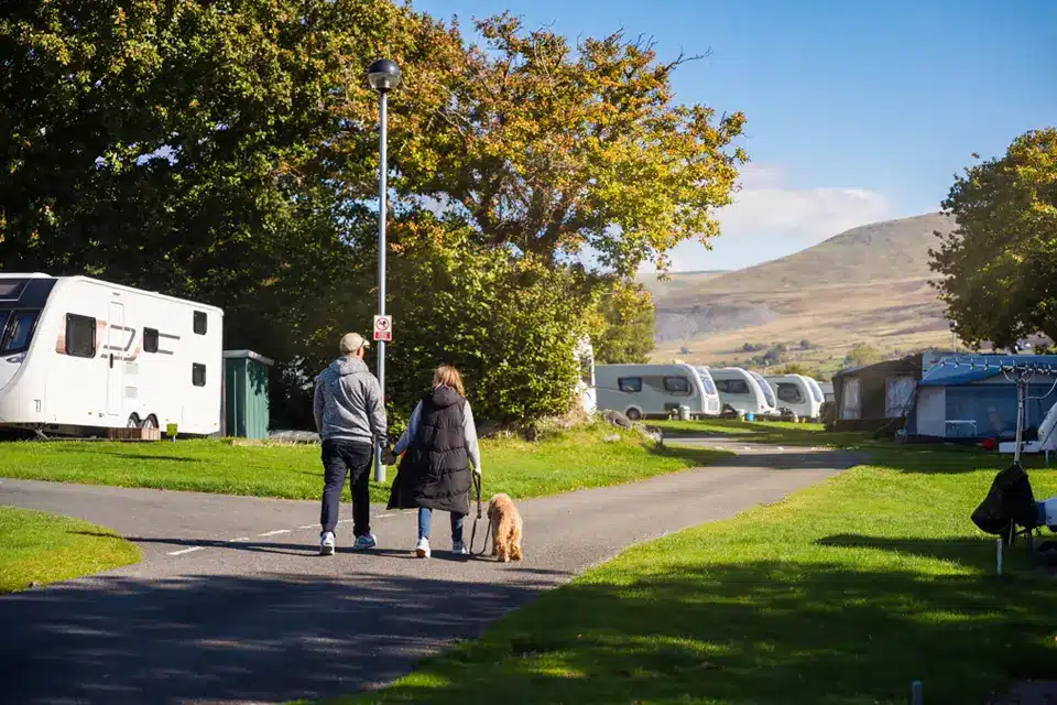 Family sitting on decking with view panoramic views overlooking Snowdonia National Park